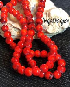 Glaspärla drawbench korallröd med svart stänk på, 6mm, 1 sträng