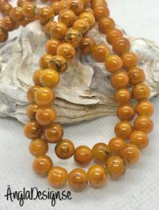 Glaspärla drawbench lejongul med svart stänk på, 6mm, 1 sträng