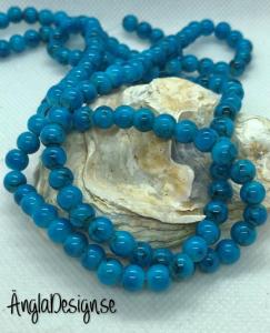 Glaspärla drawbench mörkturkos med svart stänk på, 6mm, 1 sträng