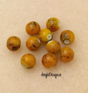 Glaspärla drawbench lejongul med svart stänk på, 8mm, 10-pack