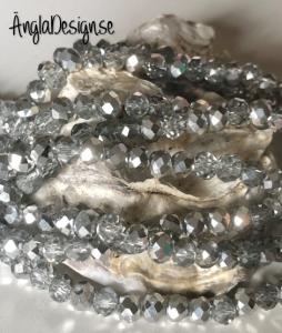 Glasrondell, facetterad 6x4mm silver, 1 sträng