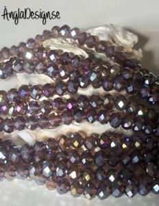 Glasrondell, facetterad 6x4mm lila med AB lyster, 1 sträng