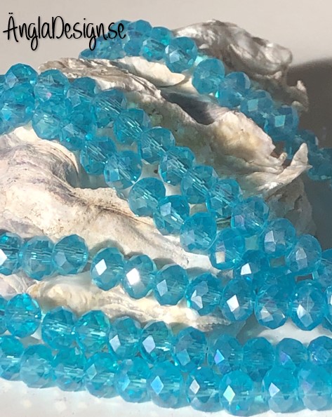 Glasrondell, facetterad 6x4mm turkos med ab lyster, 1 sträng