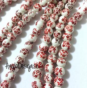 Porslinspärlor 8mm röd/orange blommiga, 10-pack