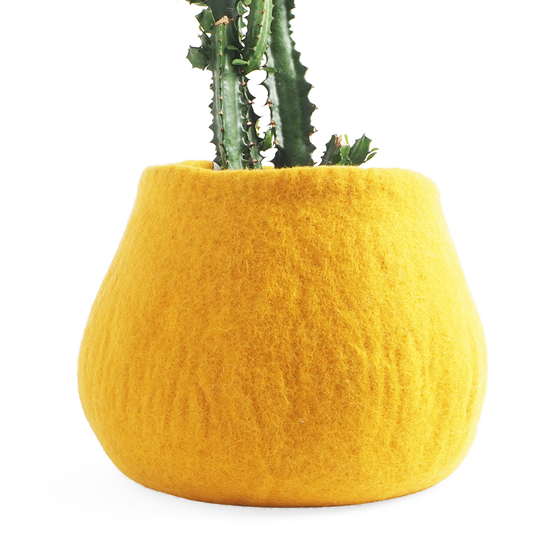 Large rounded flower pot in yellow made of wool.