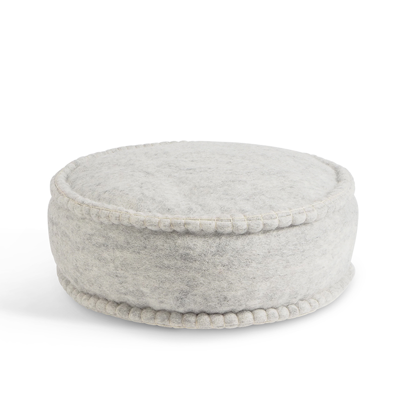 Round raw grey handmade floor cushion in 100% wool and organic leather . Filled with dinkel