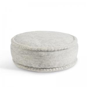 Round raw grey handmade floor cushion in 100% wool and organic leather . Filled with dinkel