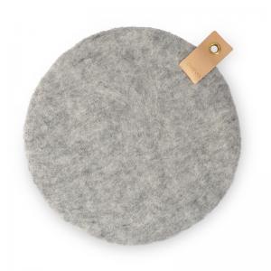 Raw grey seat cushion in wool, dyed with natural colors on one side, and raw wool on the other with a leather band.