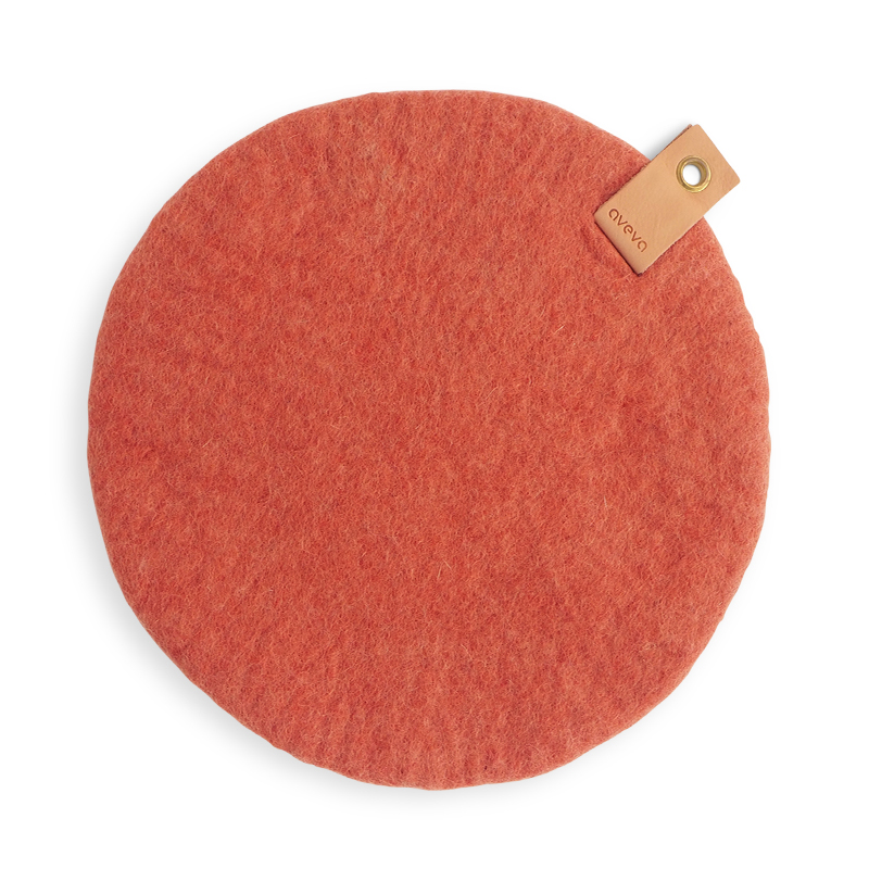 Terracotta seat cushion made with naturally dyed wool with a detail in Swedish leather that is refined through vegetable tanning and is eco certified