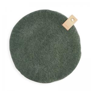 Round Moss green Seat cushion made with naturally dyed with natural colors on one side, and raw wool on the other and have a leather detail with a metal for hanging.