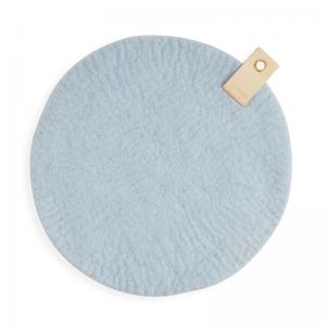 Round Seat cushion made with naturally dyed with natural colors on one side, and raw wool on the other and have a leather detail with a metal for hanging.
