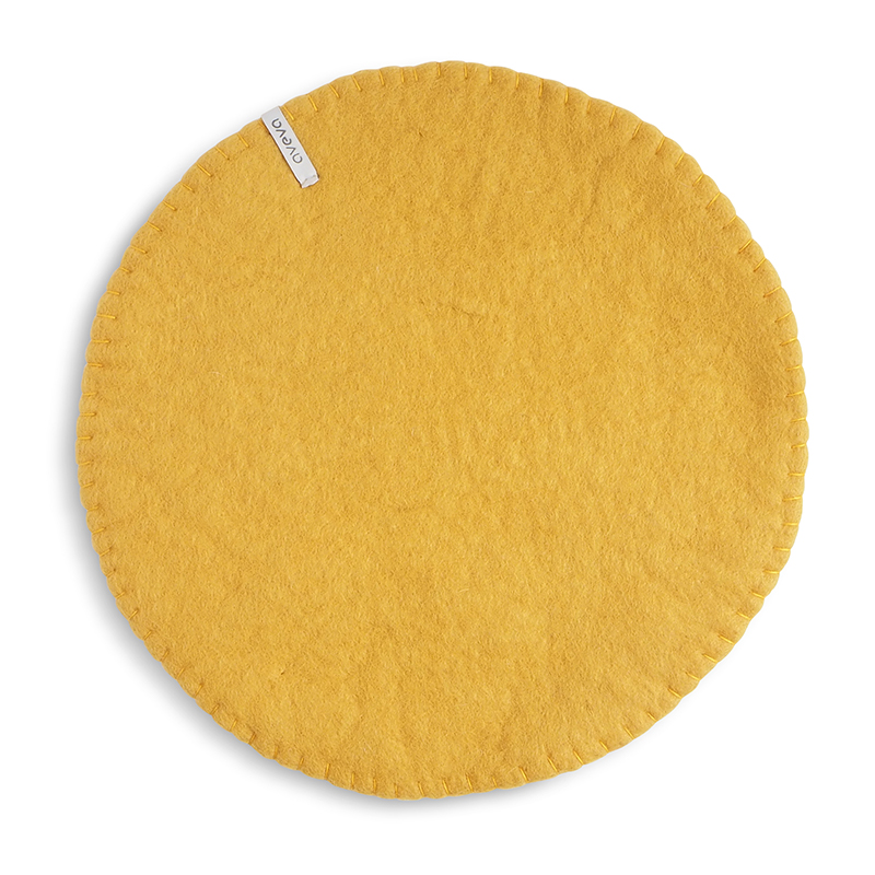 Round ochre seat cushions made with naturally dyed wool features the same colour on the top and underside,  and has a beautiful handstitched rim