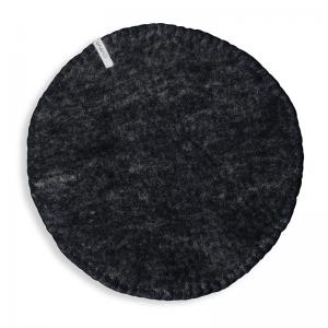 Round raw black seat cushions made with naturally dyed wool features the same colour on the top and underside,  and has a beautiful handstitched rim