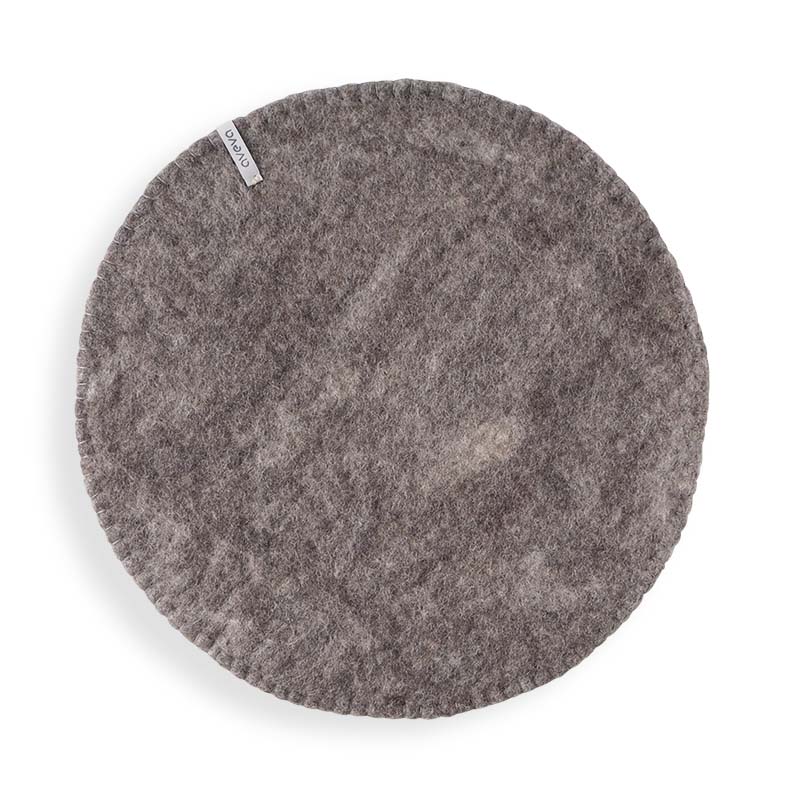 Round Raw brown seat cushions made with naturally dyed wool features the same colour on the top and underside,  and has a beautiful handstitched rim