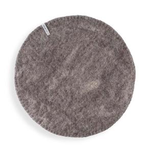 Round Raw brown seat cushions made with naturally dyed wool features the same colour on the top and underside,  and has a beautiful handstitched rim
