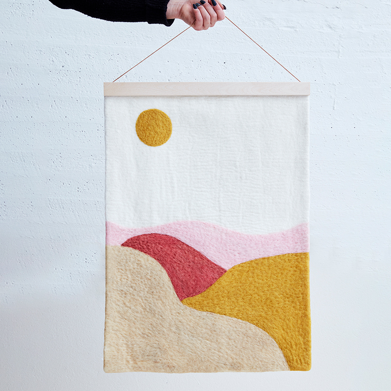 Poster in wool with motifs of a landscape.