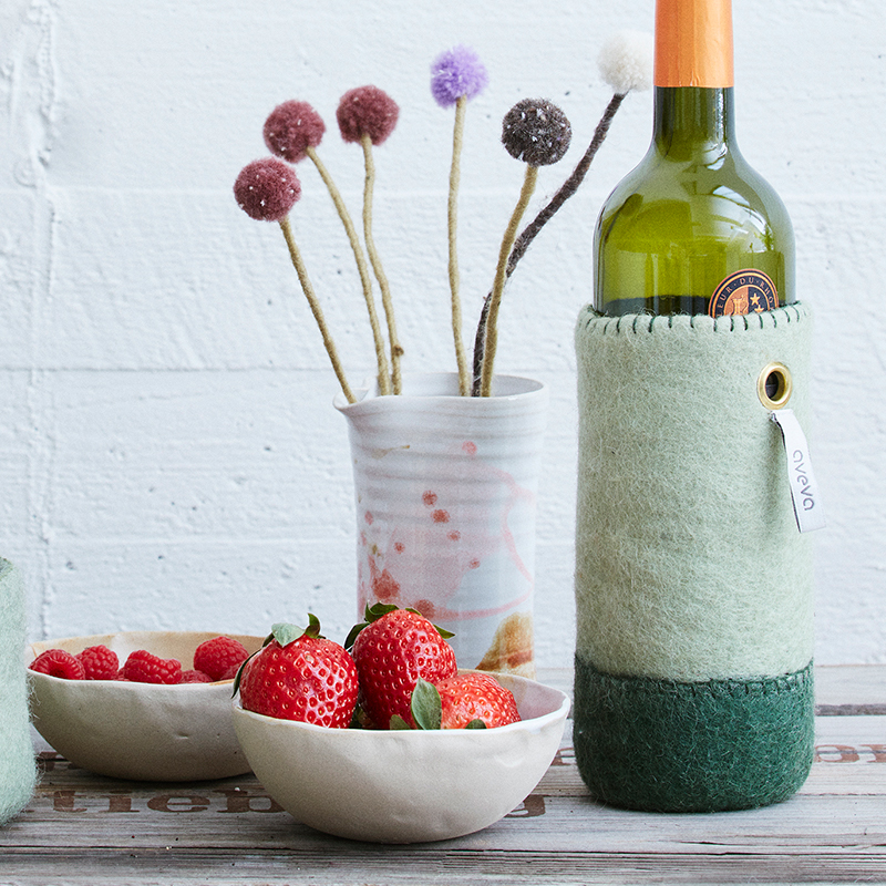 Wool container for bottles in shades of green.
