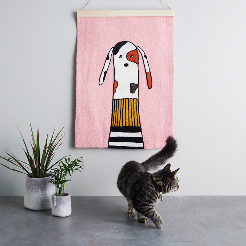 Affish i ull med motiv av en hund och en katt som tittar på affischen.