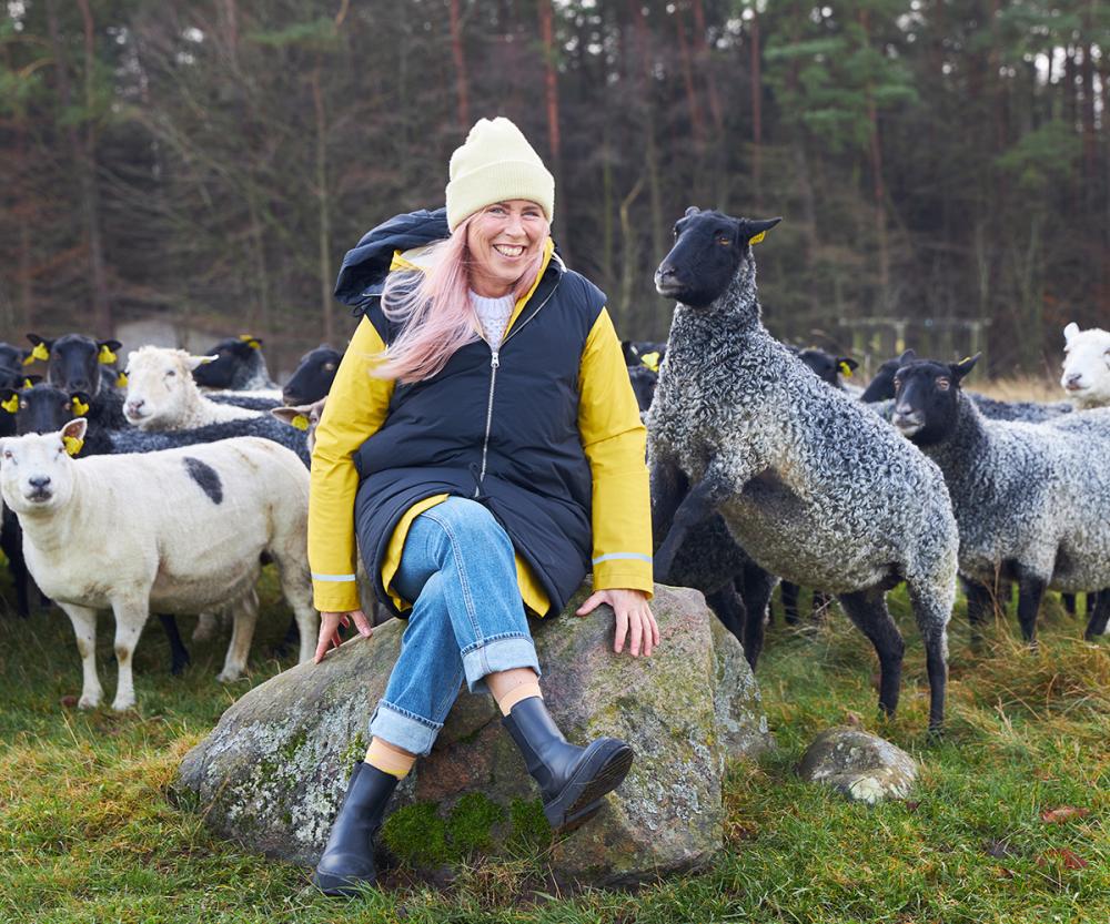 Eva, founder of Aveva design together with sheep