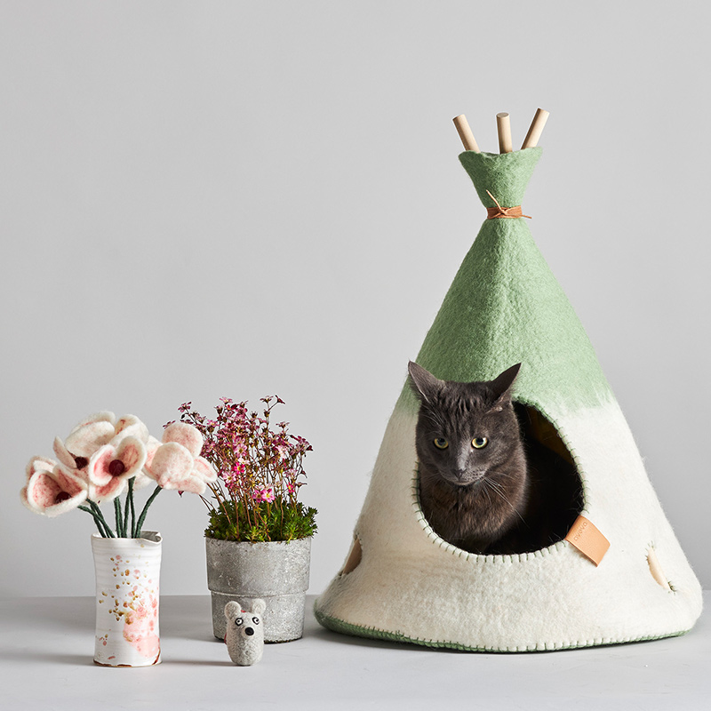 Small handmade tipi tent in natural white and sage green ombre with a grey cat.