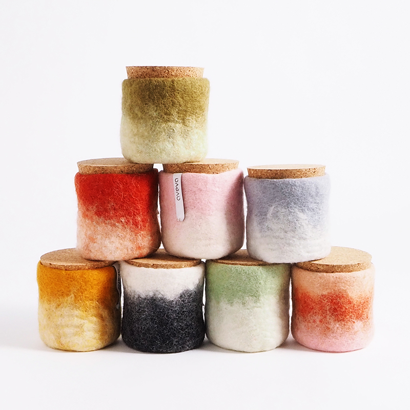 Jars in wool with a lid of light cork standing on each other.