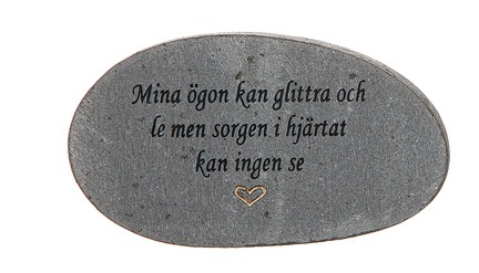 Grå sten med graverad text, Mina ögon kan glittra och le...