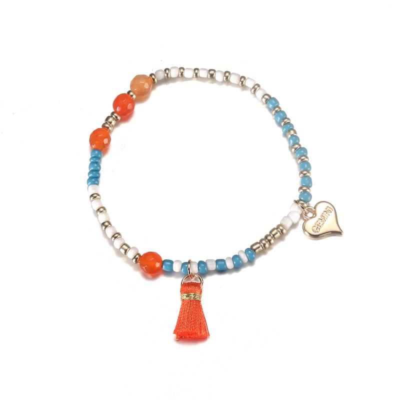 Elastiskt Armband med blå och vita pärlor med orange tofs - Gemini