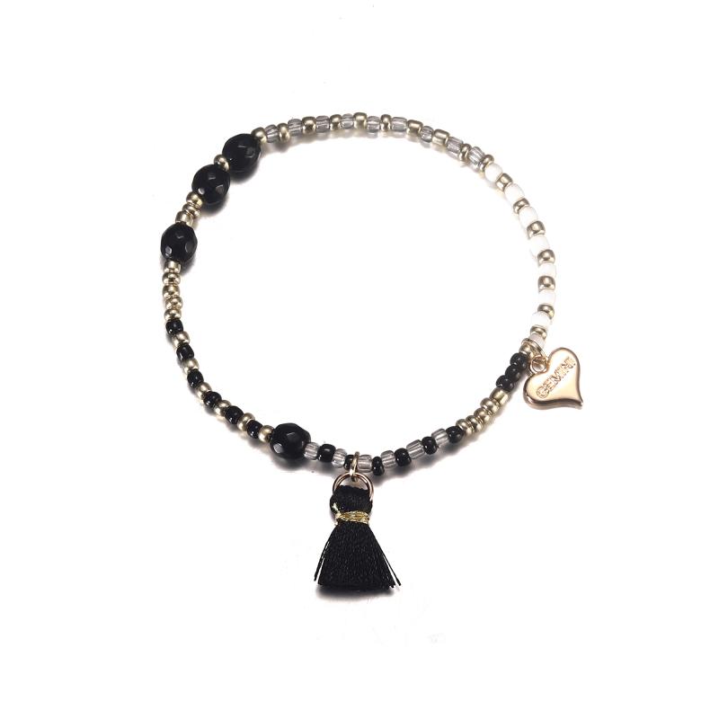 Elastiskt Armband med svarta och vita pärlor med svart tofs - Gemini