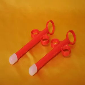 Chambers of Love’s red lube injector for safe, deep application of lubricant.