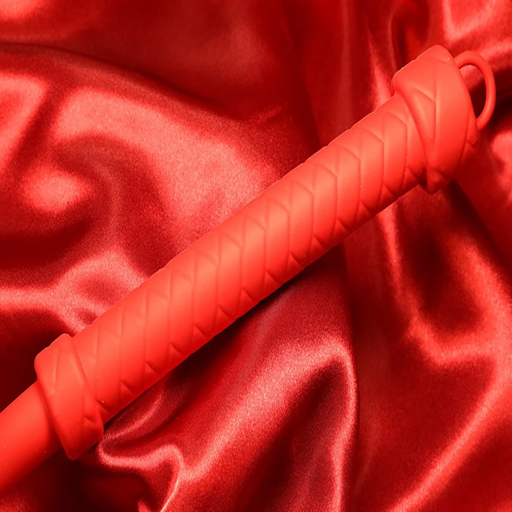 Lähikuva silikonisen single tailin punaisesta kahvasta Chambers of Lovelta – ylellinen ja ergonominen muotoilu.