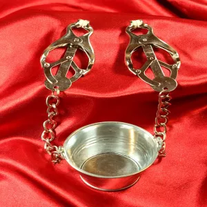 Japanese nipple clamps with metal bucket and chains on red satin fabric from Chambers of Love
