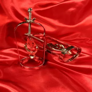 Japanese nipple clamps with metal stand from Chambers of Love on red satin fabric