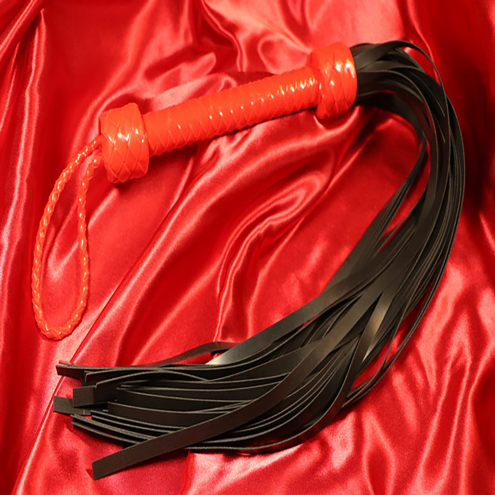 Red silicone flogger with black silicone tails and a red silicone handle from Chambers of Love. Perfect for intense, controlled impact and pleasure in wet areas or on the beach.