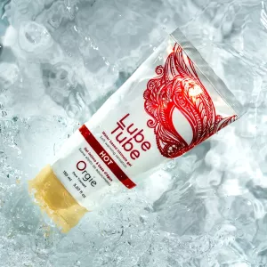 Orgie Lube Tube Hot warming water based lubricant 150 ml with gel shown on a water surface from Chambers of Love.