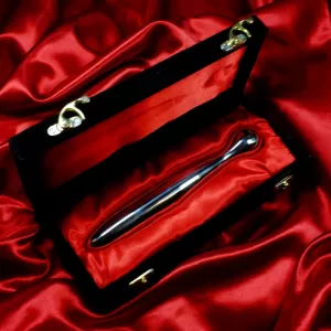 Luxurious stainless steel dildo from Chambers of Love, presented in its black box with red velvet lining, highlighting the elegant premium look.