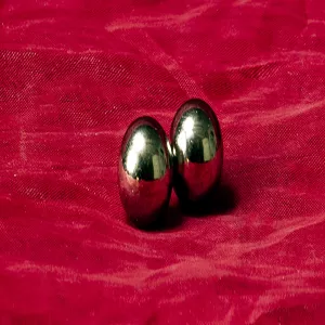 Orbs XL polished steel magnetic balls from Master Series at Chambers of Love on red fabric