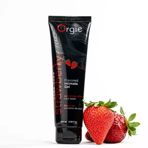ORGIE Lube Tube Erdbeere 100 ml wasserbasiertes aromatisiertes Gleitmittel – Produktbild mit Erdbeeren – Chambers of Love