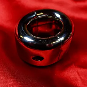 Metal ball stretcher with screw for securing around the scrotum, from Chambers of Love