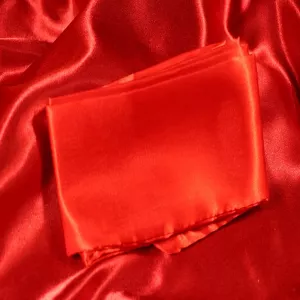 Red silk blindfold from Chambers of Love in soft silk fabric for total blackout, sensual play and soft bondage.