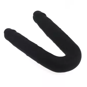 Silikoninen tupladildo Chambers of Lovelta, pidetään kädessä ja ote näkyy selvästi, kuvattu valkoista taustaa vasten.