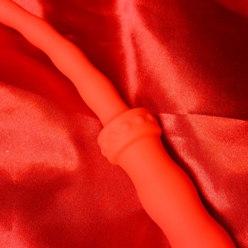 Close-up of the handle on a red silicone whip with beads, short single-tail model from Chambers of Love