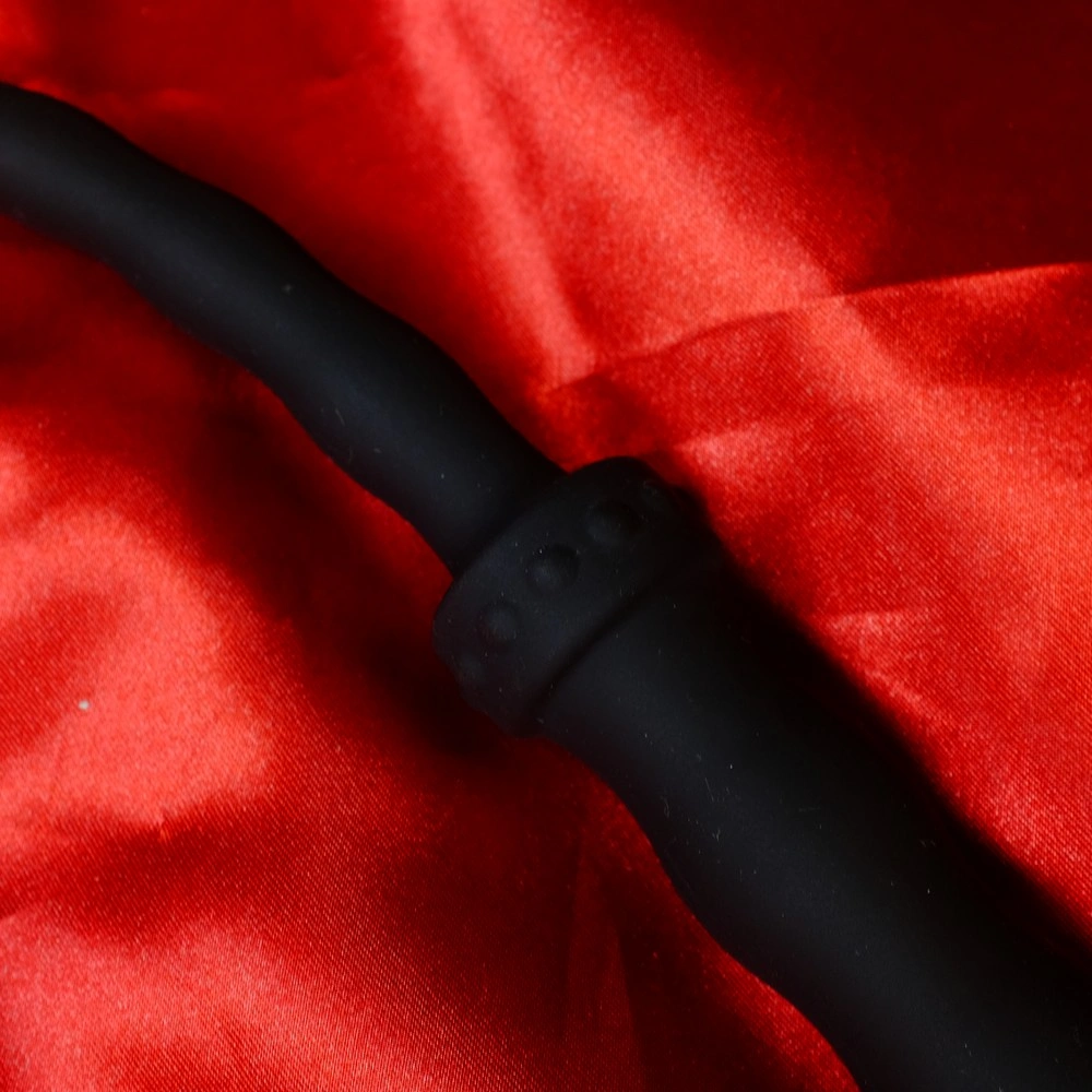 Close-up of the black handle on a silicone whip with beads, short single-tail model from Chambers of Love