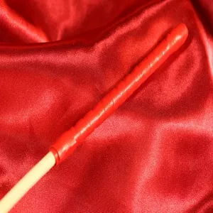 Close-up of the red handle of the Single Rotting Cane from Chambers of Love – classic discipline tool for BDSM sessions.
