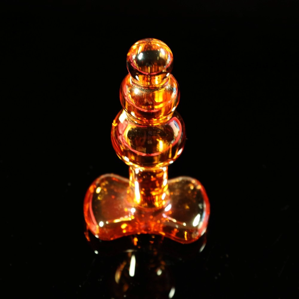 Three-bead glass anal plug from Chambers of Love, photographed from a slightly angled top view. Elegant and sleek design for pleasure and precision.