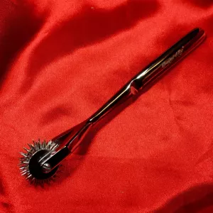 Three-row Wartenberg wheel from Chambers of Love, a medical fetish toy in satin-polished stainless steel for intense nerve stimulation on the skin.