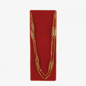 Guldfärgat halsband med 9 cylinderformade magneter.