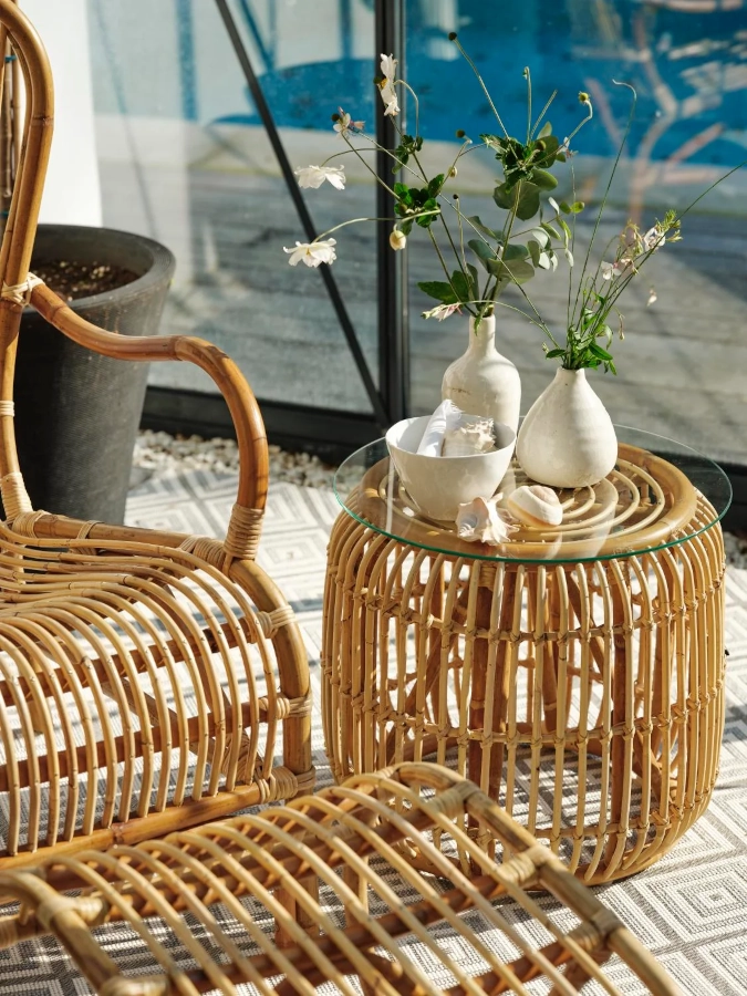 Vallda fåtölj med hög rygg från Brafab ihop med fotpall och bord i en miljö.