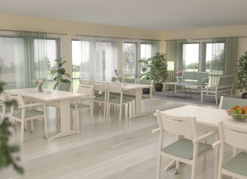 Alma karmstol från Inoff med klädd sits i en miljö.