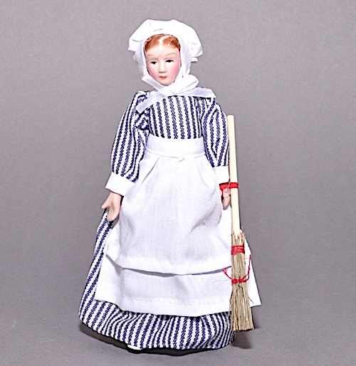 Husa hembiträde köksa Rennie med sopkvast