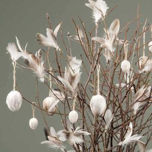 vita påskfjädrar i påskuppsättning